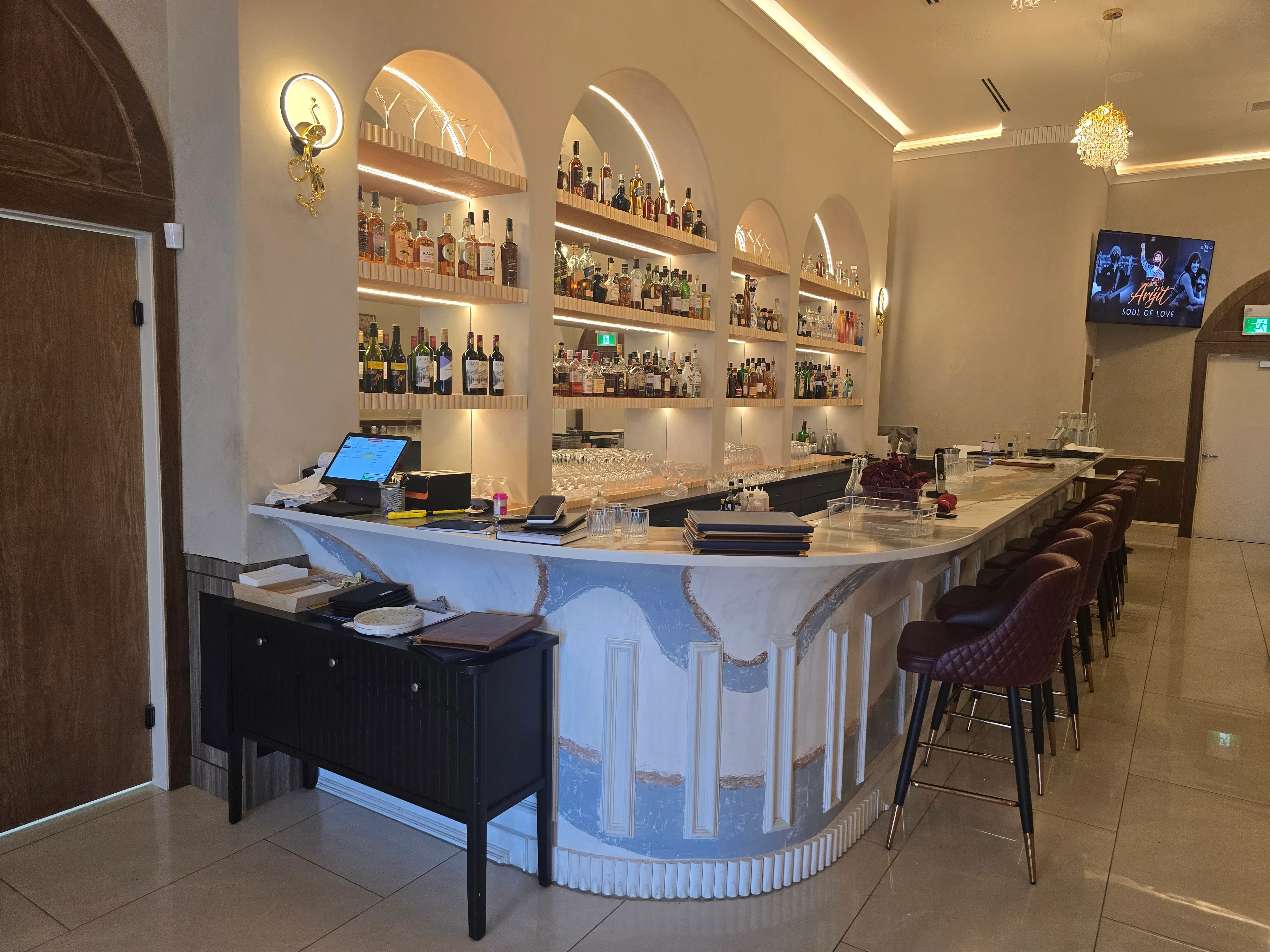 Curved marble bar counter and lounge seating at Ghazal Fine-Dine, Tamarack Edmonton