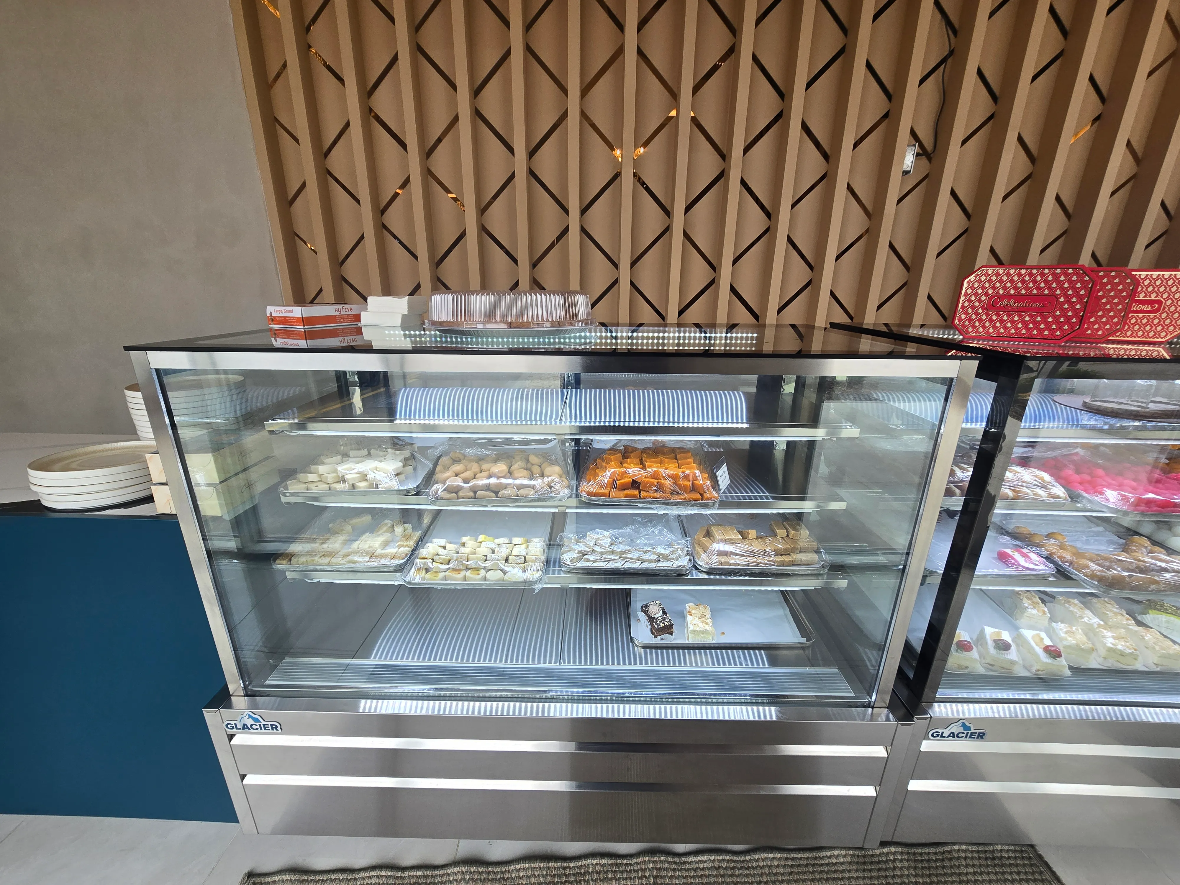 Display case of freshly made Indian sweets at Ghazal's Mithai Ghar in Tamarack, Edmonton