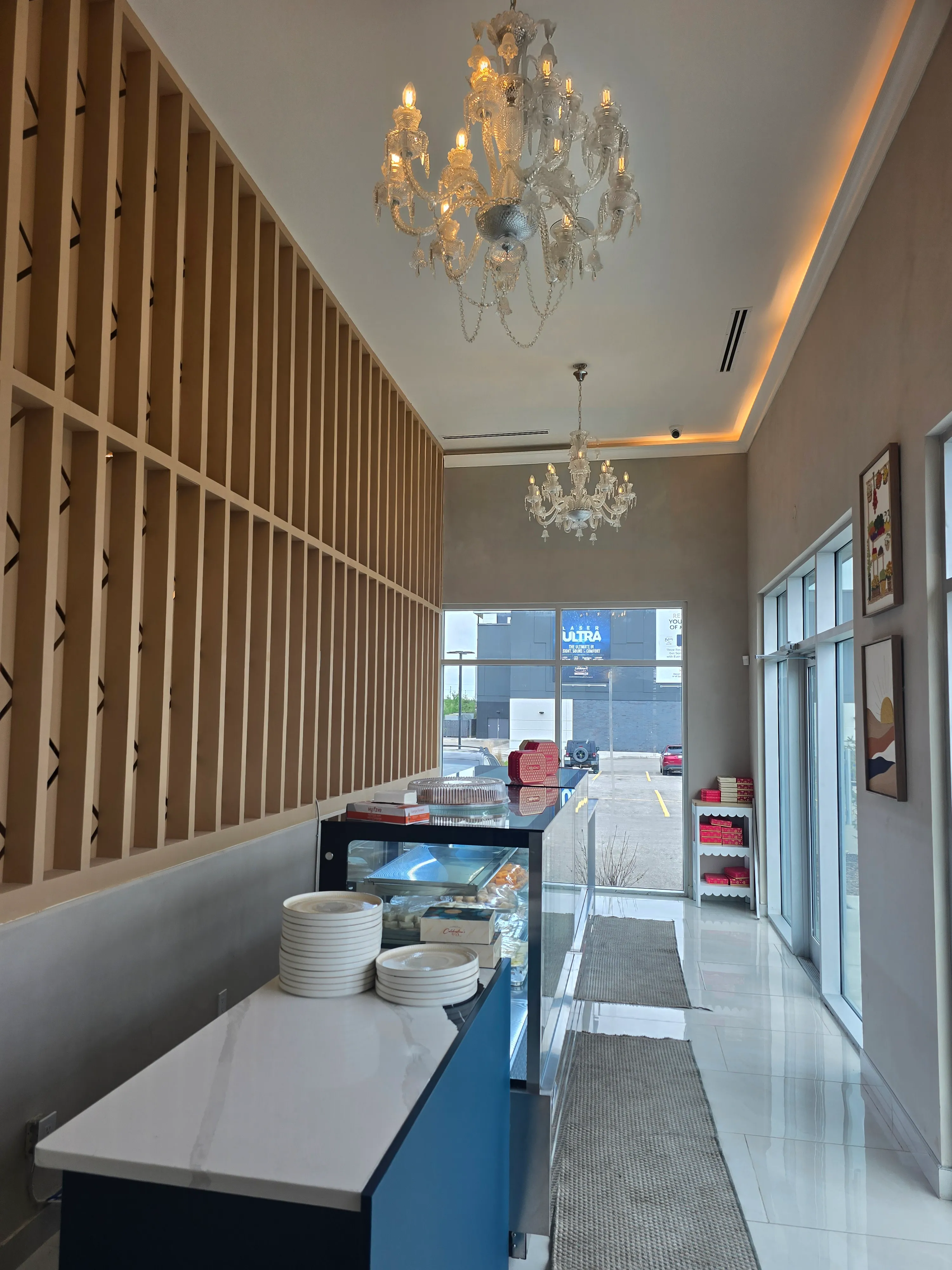Ghazal Mithai Ghar sweet-house counter with chandeliers in Tamarack, Edmonton